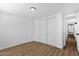 A light-filled bedroom with wood-look floors and double door closet at 2241 N Nicklaus Dr, Mesa, AZ 85215