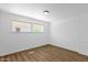 A bright bedroom with wood-look floors and a large window at 2241 N Nicklaus Dr, Mesa, AZ 85215
