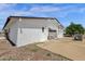 A single-story house with a low-pitched roof and a gravel and concrete yard at 2241 N Nicklaus Dr, Mesa, AZ 85215