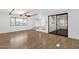 Bright living area with beamed ceilings, wood-look floors and a sliding glass door at 2241 N Nicklaus Dr, Mesa, AZ 85215