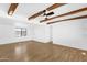 Spacious living room with wood-look floors, beamed ceilings and natural lighting at 2241 N Nicklaus Dr, Mesa, AZ 85215