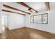 Bright living area with beamed ceilings, wood-look floors and a large window at 2241 N Nicklaus Dr, Mesa, AZ 85215
