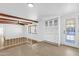 Open living area with beamed ceilings, built-in cabinetry, and a decorative glass front door at 2241 N Nicklaus Dr, Mesa, AZ 85215