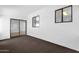 Neutral room featuring carpet, white walls and a sliding glass door at 2241 N Nicklaus Dr, Mesa, AZ 85215