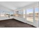 Bright sunroom with carpet, multiple windows, and access to the outside at 2241 N Nicklaus Dr, Mesa, AZ 85215