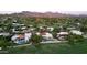 Aerial shot of a residential neighborhood with a beautiful home featuring a pool and lush landscaping at 23002 N Country Club Trl, Scottsdale, AZ 85255