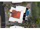Aerial view showcases a sprawling estate with a striking red tile roof, pool, and lush landscaping at 23002 N Country Club Trl, Scottsdale, AZ 85255