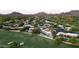 Scenic aerial view of a luxury home, golf course and mountain views at 23002 N Country Club Trl, Scottsdale, AZ 85255