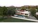 An aerial view of a modern estate features a stunning pool, pristine landscaping, and contemporary design at 23002 N Country Club Trl, Scottsdale, AZ 85255