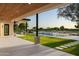 Inviting covered back porch overlooking the pool, golf course, and manicured yard at 23002 N Country Club Trl, Scottsdale, AZ 85255