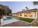This luxurious backyard features a sparkling pool and spa, modern patio, and lush landscaping for outdoor enjoyment at 23002 N Country Club Trl, Scottsdale, AZ 85255