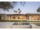 Beautiful backyard with a pool, artificial grass, and inviting outdoor space for entertaining guests at 23002 N Country Club Trl, Scottsdale, AZ 85255