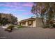 Stunning home boasts a private backyard with a pool, mature trees, and desert landscaping at 23002 N Country Club Trl, Scottsdale, AZ 85255