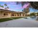 Stunning backyard with modern pool, manicured lawn, and sleek outdoor living space with fireplace under colorful sunset sky at 23002 N Country Club Trl, Scottsdale, AZ 85255