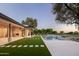 Spacious backyard with pool, patio, and lawn, perfect for outdoor entertaining and relaxation at 23002 N Country Club Trl, Scottsdale, AZ 85255