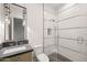 Contemporary bathroom with walk-in shower, mosaic tile, and modern vanity with pendant lighting at 23002 N Country Club Trl, Scottsdale, AZ 85255