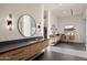 Modern bathroom with a double vanity, sleek fixtures, and a glass-enclosed shower at 23002 N Country Club Trl, Scottsdale, AZ 85255