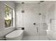 Beautiful bathroom featuring a soaking tub, walk-in shower, and natural light at 23002 N Country Club Trl, Scottsdale, AZ 85255