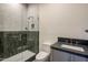 Modern bathroom featuring a glass-enclosed shower with stylish tile work and a sleek vanity with a gray countertop at 23002 N Country Club Trl, Scottsdale, AZ 85255