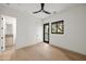 Bright bedroom with hardwood floors and views into a bathroom with patterned tile floor at 23002 N Country Club Trl, Scottsdale, AZ 85255