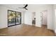 Bright bedroom with hardwood floors, a modern ceiling fan, and en-suite bathroom, offering ample natural light at 23002 N Country Club Trl, Scottsdale, AZ 85255