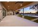 Expansive covered patio with wood ceilings, an outdoor fireplace, and seamless access to the pool and landscaped backyard at 23002 N Country Club Trl, Scottsdale, AZ 85255