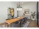 A spacious dining room with a modern chandelier and an art-filled wall at 23002 N Country Club Trl, Scottsdale, AZ 85255