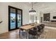 Dining room boasts a modern chandelier, access to the outdoor area, and flows seamlessly into living areas at 23002 N Country Club Trl, Scottsdale, AZ 85255