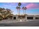 Attractive exterior featuring a modern house with palm trees, manicured landscaping, and a paved driveway at 23002 N Country Club Trl, Scottsdale, AZ 85255