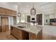 Open concept kitchen with large island, modern lighting, and seamless flow into the living space at 23002 N Country Club Trl, Scottsdale, AZ 85255