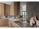 Elegant kitchen with mirrored backsplash, wood cabinets, and marble countertop at 23002 N Country Club Trl, Scottsdale, AZ 85255