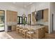 Stunning kitchen features a large island with marble countertops and seating at 23002 N Country Club Trl, Scottsdale, AZ 85255