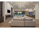 Expansive living area showcases a fireplace, views of the outdoor space, and seamless access to the kitchen at 23002 N Country Club Trl, Scottsdale, AZ 85255