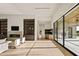 Bright living room with fireplace, built-in shelving, and sliding glass doors at 23002 N Country Club Trl, Scottsdale, AZ 85255