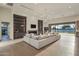 A bright living room features a large sectional sofa, a fireplace, and access to the pool area at 23002 N Country Club Trl, Scottsdale, AZ 85255