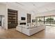 Open-concept living room features custom cabinets, a fireplace, and views of the backyard at 23002 N Country Club Trl, Scottsdale, AZ 85255