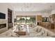 Spacious living room with modern lighting, fireplace, and backyard views at 23002 N Country Club Trl, Scottsdale, AZ 85255