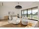 Spacious main bedroom with seating area, modern decor, and a large window at 23002 N Country Club Trl, Scottsdale, AZ 85255