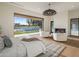 Bright main bedroom boasts a fireplace, plush seating, and expansive views of the pool at 23002 N Country Club Trl, Scottsdale, AZ 85255