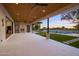 Spacious covered patio with a cozy fireplace and a view of the backyard, pool, and serene surroundings at 23002 N Country Club Trl, Scottsdale, AZ 85255