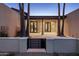 Private covered patio, surrounded by palm trees, offering a tranquil outdoor space at 23002 N Country Club Trl, Scottsdale, AZ 85255