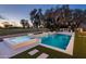 A luxurious pool and spa feature a waterfall, lush landscaping, and a golf course view, perfect for outdoor relaxation at 23002 N Country Club Trl, Scottsdale, AZ 85255