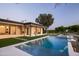 Inviting swimming pool and spa surrounded by lush greenery, perfect for relaxation and recreation at 23002 N Country Club Trl, Scottsdale, AZ 85255