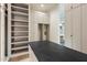 A spacious walk-in closet features open shelving and custom cabinets with modern lighting at 23002 N Country Club Trl, Scottsdale, AZ 85255