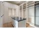 A spacious walk-in closet with custom shelving, drawers, and a center island at 23002 N Country Club Trl, Scottsdale, AZ 85255