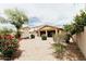Spacious backyard featuring decorative trees and plants set in desert landscaping with a covered patio at 25640 N 108Th Dr, Peoria, AZ 85383