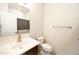 Neutral bathroom with tile floors featuring a single vanity, toilet, and tub with shower curtain at 25640 N 108Th Dr, Peoria, AZ 85383