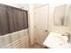 Neutral bathroom with tile floors featuring a single vanity, toilet, and tub with shower curtain at 25640 N 108Th Dr, Peoria, AZ 85383