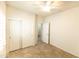 Bright bedroom with tile floors features a ceiling fan and closet with sliding doors at 25640 N 108Th Dr, Peoria, AZ 85383