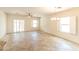 Bright living room with neutral walls, shuttered windows, and a chandelier at 25640 N 108Th Dr, Peoria, AZ 85383